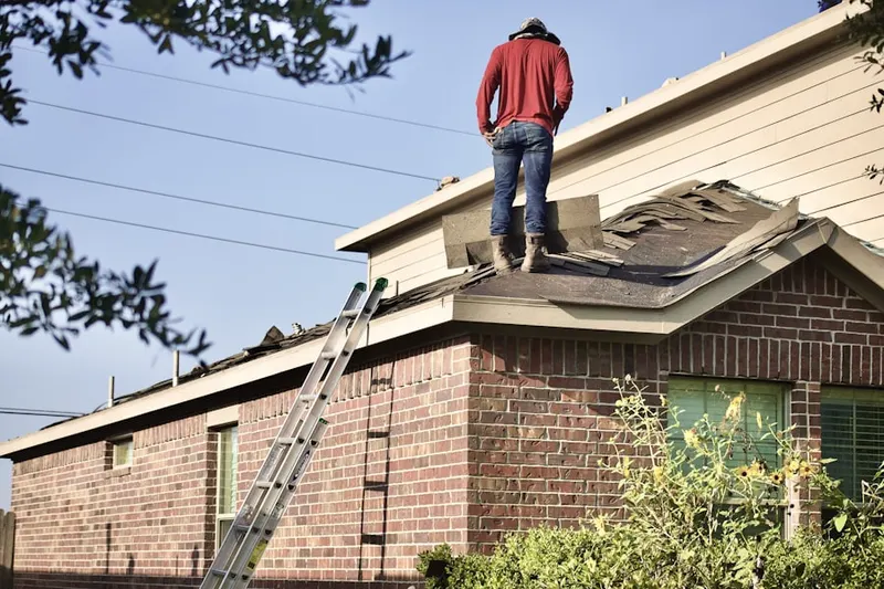 Professional roofer working on a residential roof in Fairless Hills